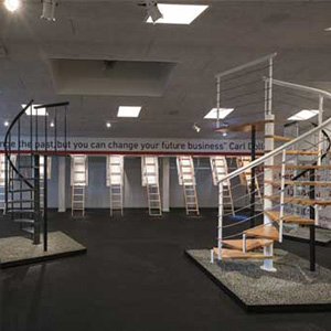 Foto degli interni dello showroom Dolle nel 2018, con diversi modelli e design di scale in esposizione.